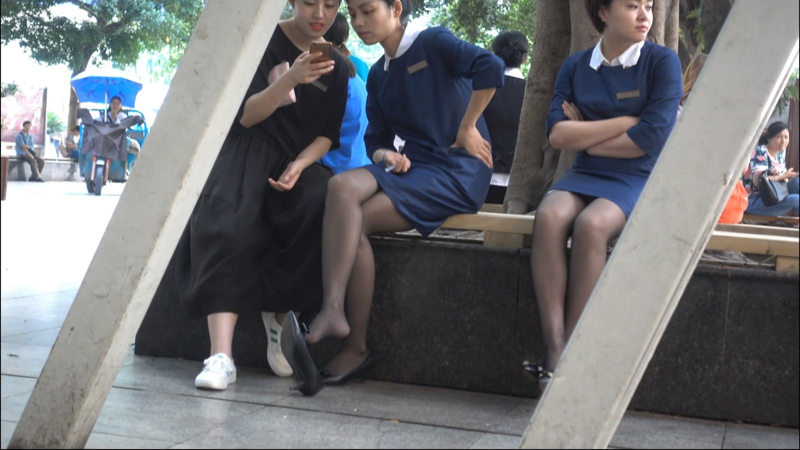 Uniformed women and dangling legs